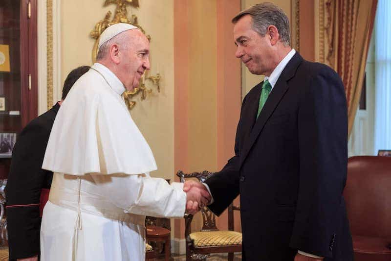 Speaker of the House John Boehner shakes hands with Pope Francis, symbolizing the Catholic Church and politics