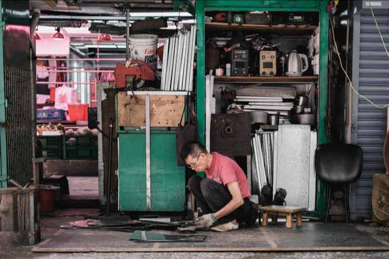 The preferential option for the poor still requires the poor to take responsibility, which is represented by a young man working in a garage