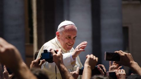 Pope Francis waves to crowd in St. Peter's square.