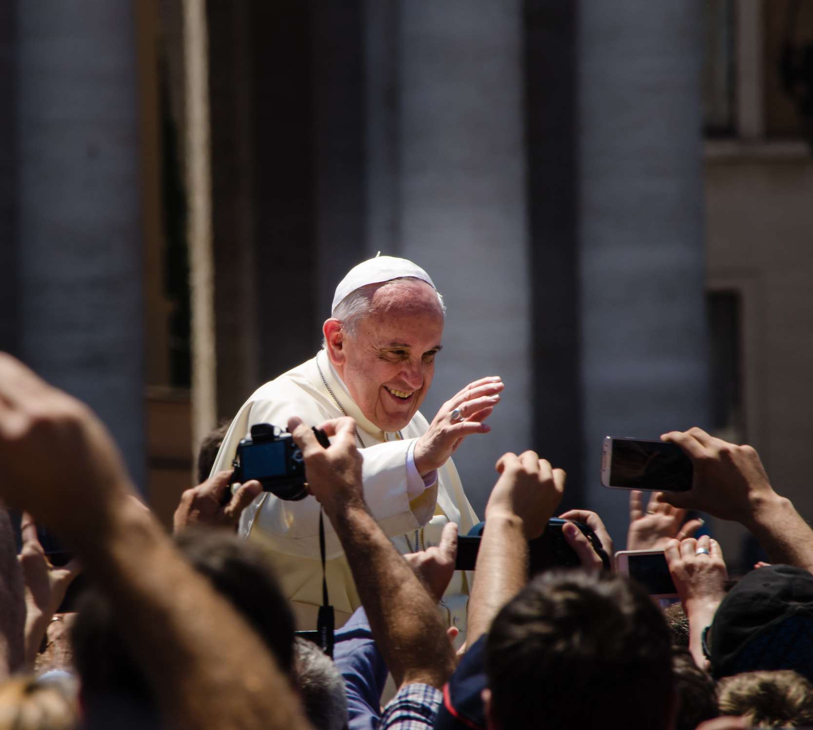 Pope Francis waves to crowd in St. Peter's square.