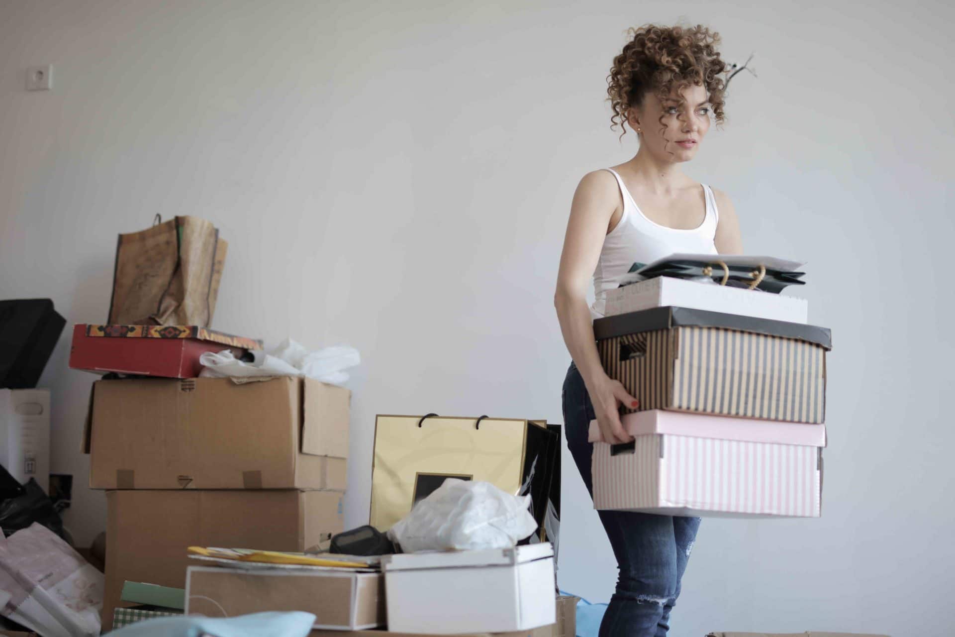 A woman gets rid of boxes of junk, showing how we could start dealing with consumerism