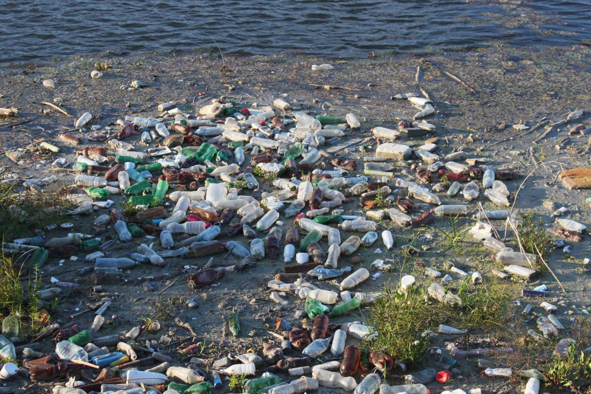 A pile of plastic garbage on the beach symbolizes the environment crisis
