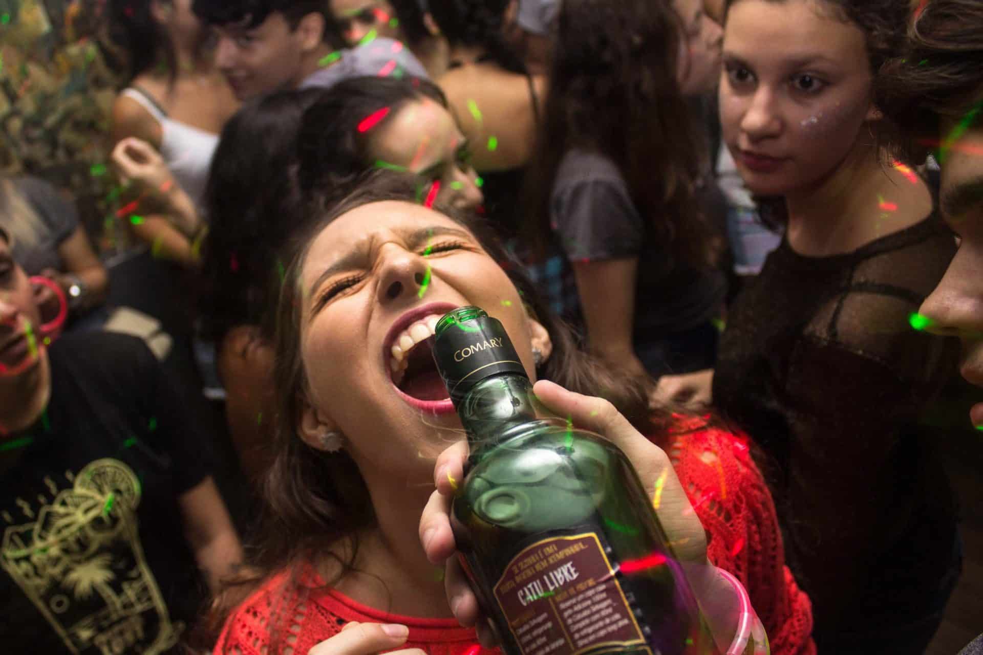 A young woman drinking liquor straight from the bottle at a party symbolizes the inadequate view of man that underpins the environment crisis