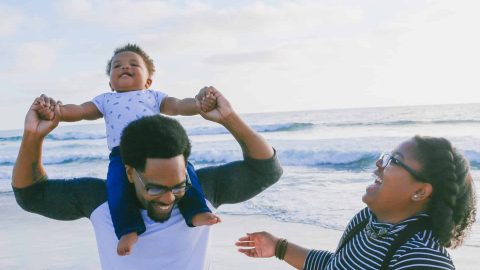 family-beach-husband-wife-mother-father-child-son-boy-happy-shoulders-ocean