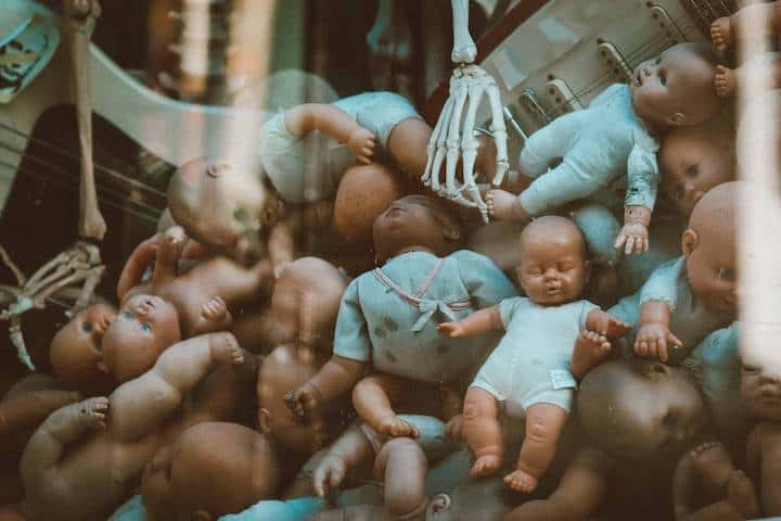 A pile of trashed dolls and bones symbolizing the grave crime and tragedy of abortion.