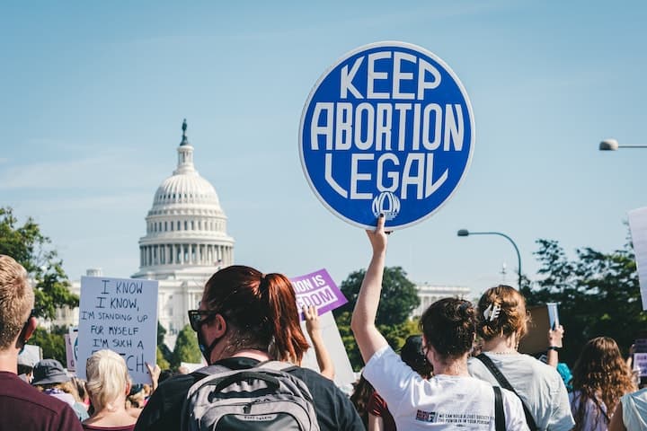 A protestor holds up a sign saying that abortion should be legal.