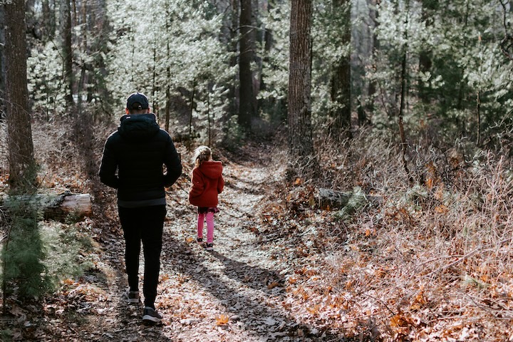 A father and daughter hike a trail through the woods together Pope Francis teaches an integral ecology. Caring for the environment is inseparable from caring for humanity.