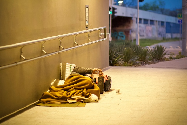 A homeless man sleeps under a tunnel as evening approaches Pope Francis connects care for the environment with care for the poor.