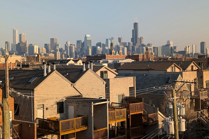 Historical racism in the United States is shown by a black and white photograph of a black worker polishing a window with a "Whites Only" sign